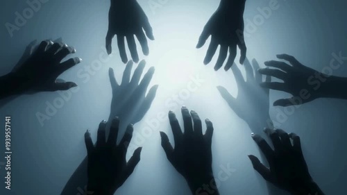 Multiple hands reaching upwards towards a bright light source from below, symbolizing hope, desperation, or a collective effort.