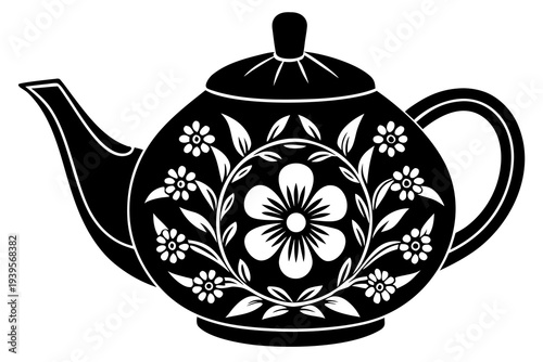 Elegant black teapot with intricate floral motif and leaf design on white background for traditional tea lovers