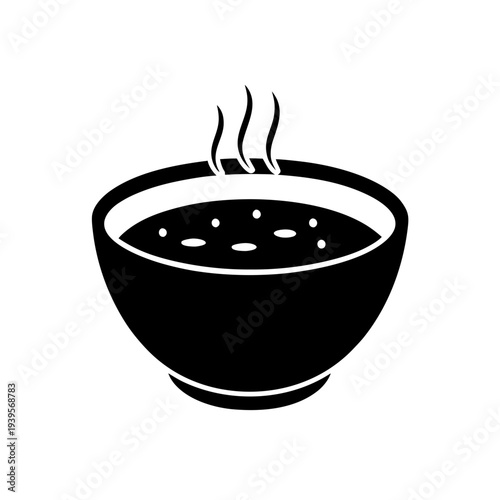 Black bowl of steaming hot soup with rising vapor against a plain background