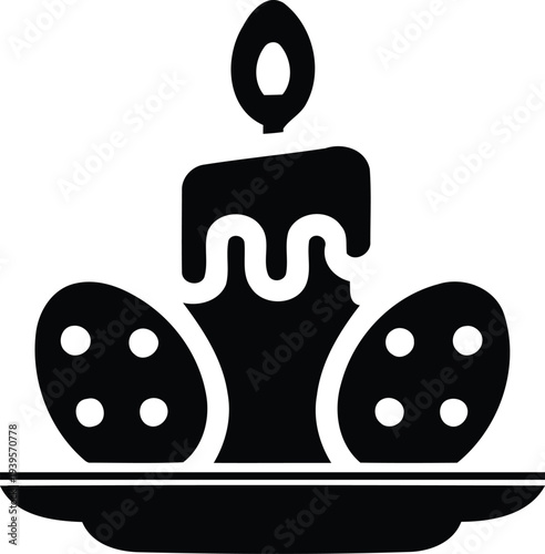 Easter eggs and a burning candle on a serving platter