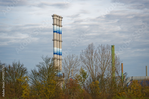 Photos Three tall stacks and smaller pipes rising from industrial building