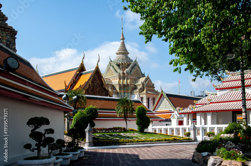 A landscape shot of the scripture hall at Wat Pho in Bangkok under a blue sky