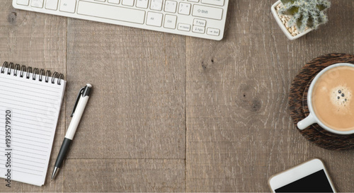 Cozy workspace with laptop, coffee, and notebook on wooden desk