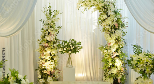 Elegant wedding arch with white flowers and lush greenery decoration