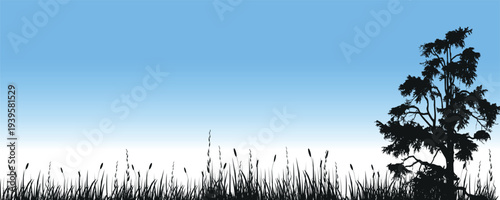 Silhouette of Lone Tree and Tall Grass Against Blue Gradient Sky