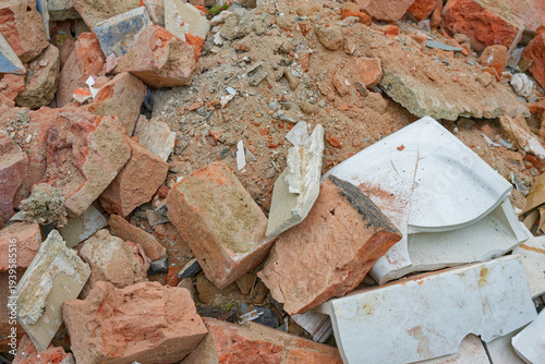 Construction debris pile with broken bricks tiles and ceramic shards