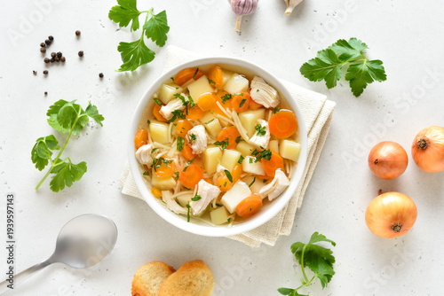 Delicious chicken noodle soup with vegetables in bowl