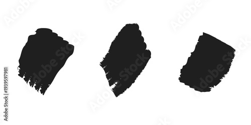Three distinct abstract black ink brush stroke splatters isolated on a white background for graphic design elements