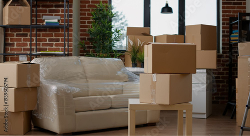 Modern living room with furniture wrapped in plastic during move