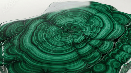 Polished green malachite stone texture background with dramatic swirling emerald pattern, rare luxury mineral surface perfect for exclusive brand premium product or high-end design