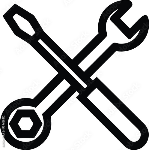 A crossed wrench and socket wrench lie on a surface.