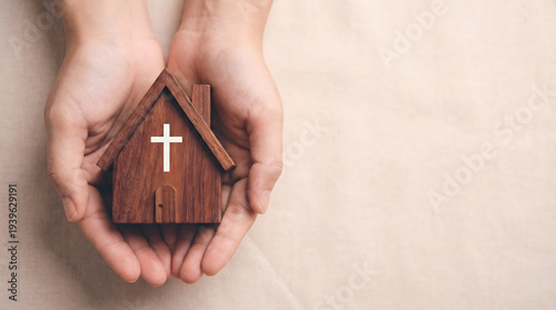 Wallpaper Mural Hands holding wooden house with Christian cross symbol, symbolizing faith and home Torontodigital.ca