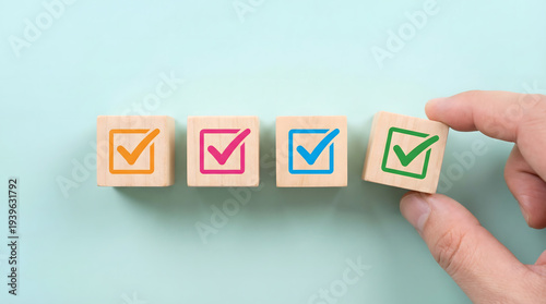 Wallpaper Mural Hand selects final colorful checkmark from row of wooden blocks Torontodigital.ca