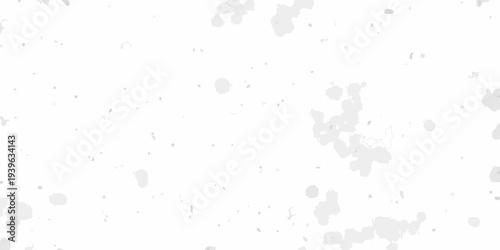 Abstract background with scattered grey splatters on a white surface