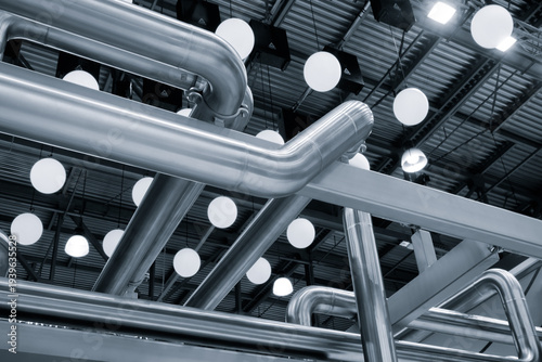 Industrial medicine production machine in pharmaceutical factory with many shiny stainless steel parts as industrial concept background