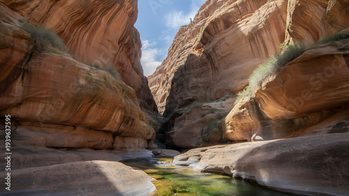 Serene canyon landscape with green river flowing through rugged sandstone formations