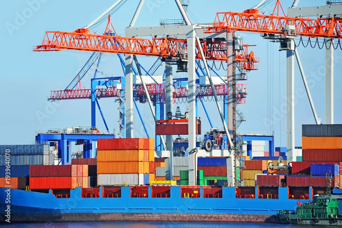 Crane loading container to cargo ship deck