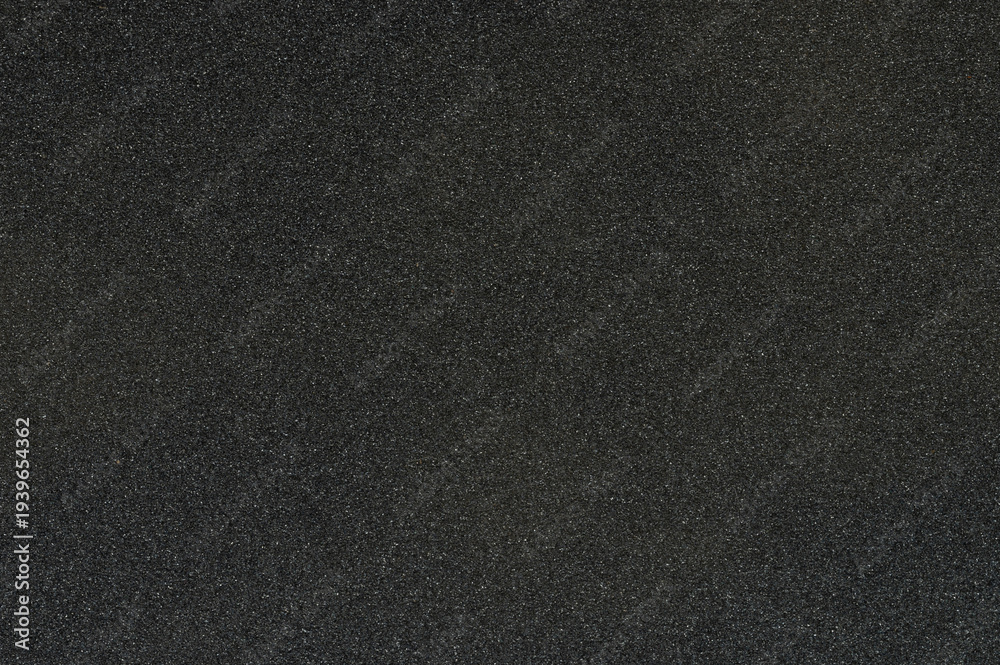 Fototapeta premium Black sandpaper texture with rough surface showing fine grain details clearly