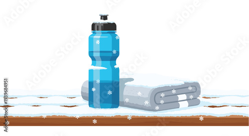A blue water bottle and a folded grey towel, both decorated with snowflakes, rest on a snow-dusted wooden surface.
