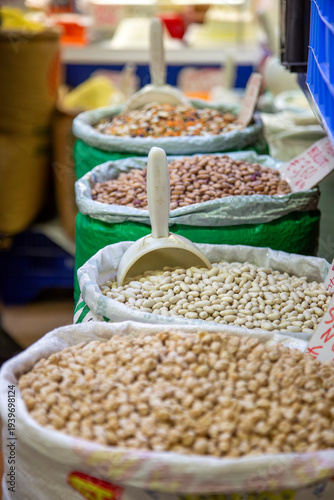 Bags of legumes are put up for sale at a farmers' market.