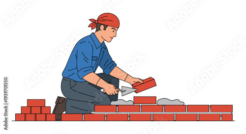 A male construction worker, wearing a blue shirt and a red bandana, kneels to lay red bricks with a trowel.