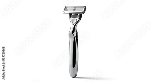 A shiny safety razor stands upright on a clean surface indoors.