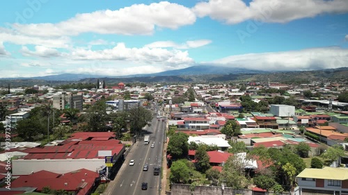 Aerial above streets in city of Alajuela Costa Rica on sunny day in February near SJO Airport