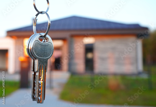 Buying home. Bunch of keys at modern private home. Concept of buying real estate, closing a deal, or moving into new home. Keys of new house. Relocation houseowner. Real estate purchase. 