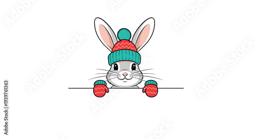 Adorable grey rabbit wearing a cozy red and teal winter beanie with matching mittens peeking over a white edge for seasonal holiday greeting.