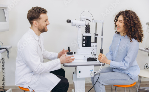 Принти на полотні Ophthalmologist conducting an eye exam, a smiling patient receiving vision care