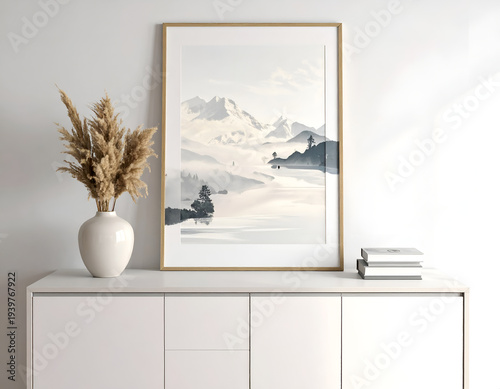 Interior serene mountain scene, vase, books on white sideboard