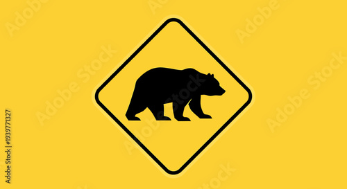 Vibrant yellow caution sign featuring a black bear silhouette, symbolizing a warning for wildlife presence and promoting safety in natural outdoor environments and wilderness areas