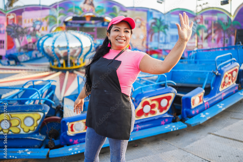 Fototapeta premium Latin woman entrepreneur waving at amusement fair