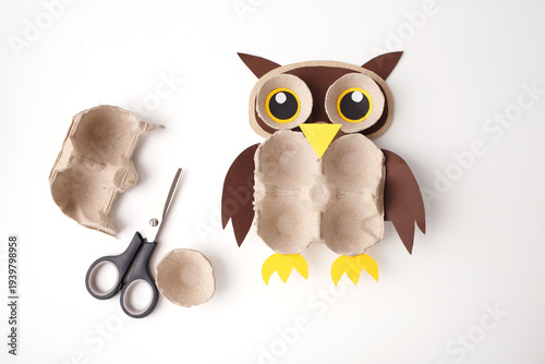 Creative kids diy owl craft made from recycled egg carton paper scissors pine cone branch. Ideal for preschool education elementary school hobby blogs toy stores and art therapy centers