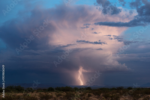Distant thunderstorm and lightning strike at blue hour