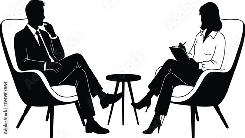 Business Partners Discussing Strategy and Taking Notes While Sitting in Modern Office Armchairs Side by Side Together
