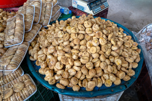 Dried figs displayed in bulk and packages at a traditional farmers market