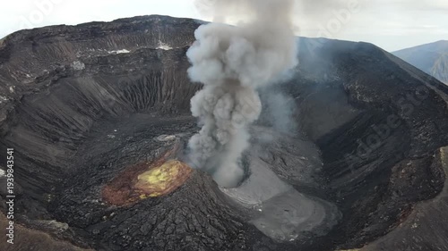 Volcanic eruption with smoke and lava in dark rugged landscape with dramatic cloudy lighting for geology