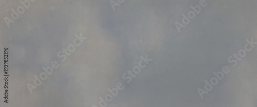 Neutral gray concrete or plaster texture with soft cloudy gradients, ideal minimal background for modern design.