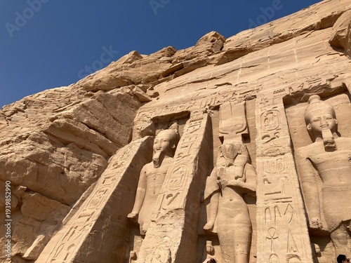 ASWAN, EGYPT - NOVEMBER 8, 2025: Panoramic view of Abu Simbel Temple complex with monumental statues of Ramses II and desert landscape in southern Egypt
