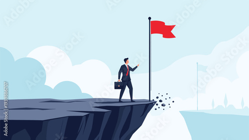 Businessman standing at the edge of a crumbling cliff with a red flag, representing the achievement of a dangerous goal or final destination.