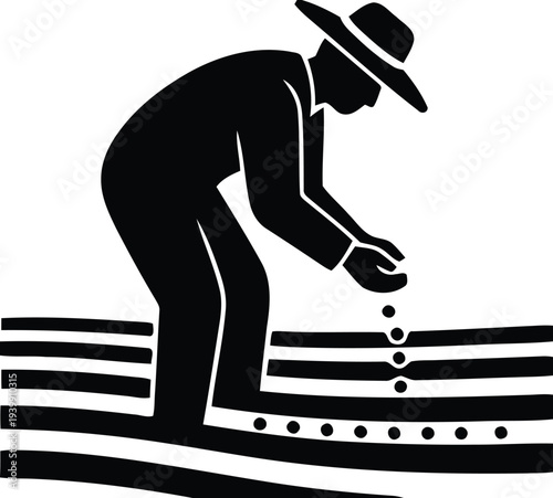 Man in hat planting seeds in a field