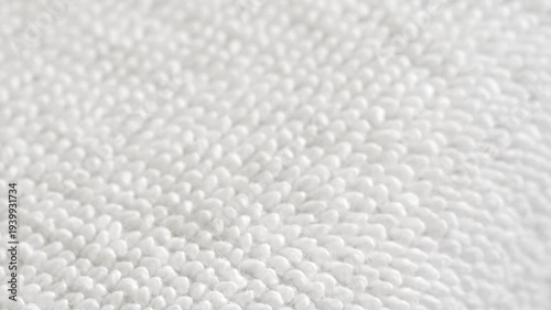 Macro panning shot of clean white towel fabric texture. Soft cotton material surface background. Concept of hygiene, laundry, spa and bath.