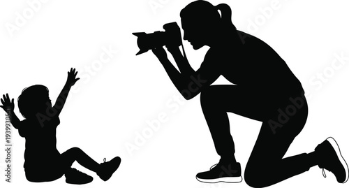 Black Silhouette of Female Photographer Kneeling to Take Photo of Small Child Sitting with Raised Arms for Family Photography Concepts