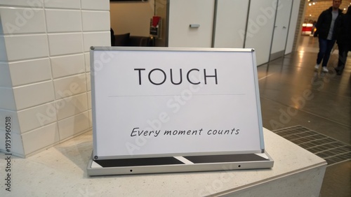 Modern signage display for interactive experience inviting visitors to engage with the phrase 