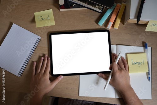 Canvas Print Mockup of a woman's hands holding tablet with blank white screen while sitting a
