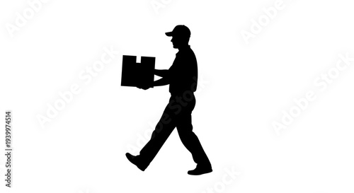 Man in silhouette walking while carrying a large box