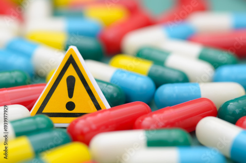 Healthcare Safety Warning Concept with Caution Sign and Medical Capsules