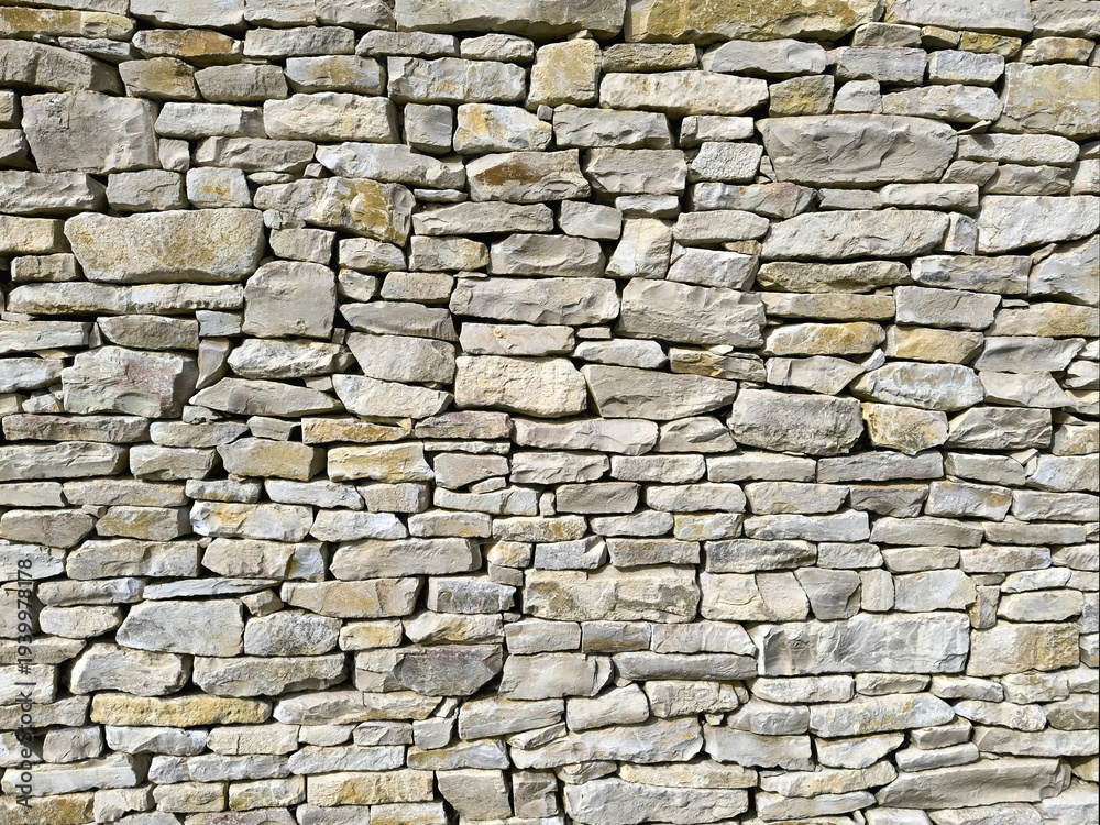 Obraz premium Natural Stone Wall Texture Background with Irregular Stacked Rocks