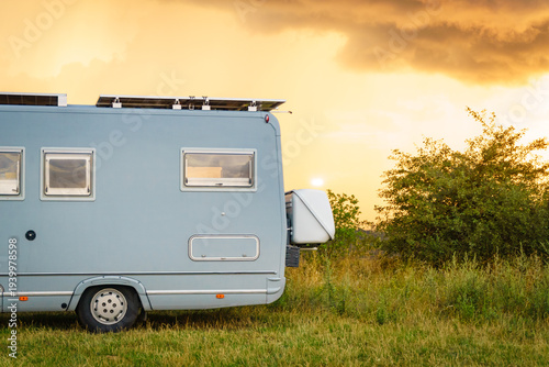 Sunset sky over caravan camping on nature.